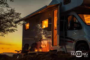 Master of the Campground: A luxury Class C motorhome setup with the best 2026 RV gift ideas, including lanterns and comfortable outdoor seating.
